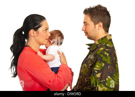 Mother holding baby boy and talking with her military husband isolated on white background Stock Photo