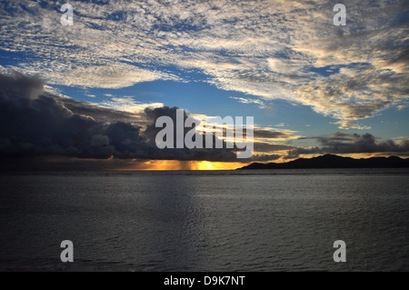 Sunset on the Island of Praslin from La Digue Island, Seychelles Stock Photo