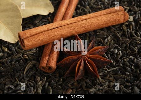 Aniseed star, cinnamon sticks, bay leaves with tea mixture Stock Photo
