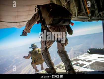 US Marine special force members from the Maritime Raid Force leaps off the back of a KC-130J Hercules during high altitude, high opening parachute operations June 15, 2013 over King Faisal Air Base in Jordan. Stock Photo