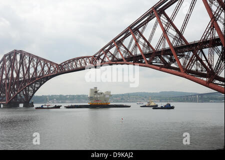 The Forth, near Edinburgh, UK. 21st June, 2013. Final piece of new aircraft carrier entering under the Forth Bridge near Rosyth. The section of aircraft carrier was built in Scotstoun and was being taken to the Rosyth dockyard Credit:  Linda Jones/Alamy Live News Stock Photo