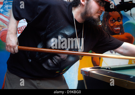 Young man playing pool at the Bar The Love Boat, Bob Marley T-shirt, Negril, Jamaica Stock Photo