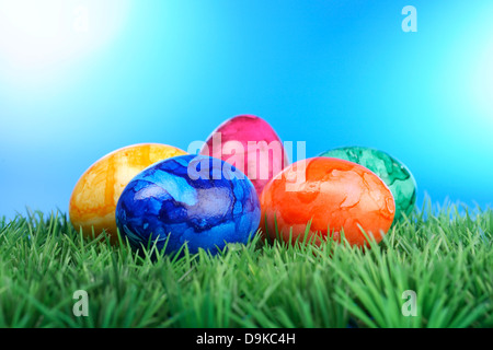 Coloured Easter eggs on lawn, Colored Easter eggs on Grass Stock Photo