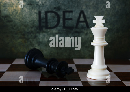 Idea text on wall with chess figures Stock Photo