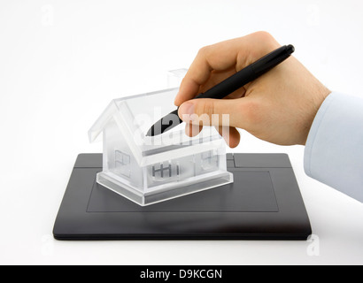 Design new house. Digital tablet and crystal house. Stock Photo