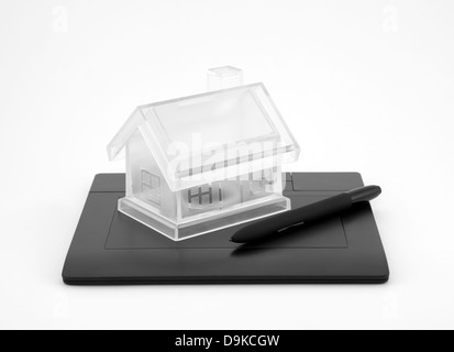 Design new house. Digital tablet and crystal house. Stock Photo
