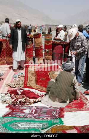 Afghan carpets on sale, transborder market near Ishkashim on the border between Tajikistan and Afghanistan Stock Photo