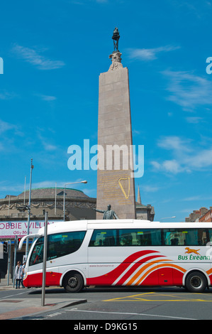 Bus Eireann company coach in front of The Parnell Monument (1911) O'Connell street upper central Dublin Ireland Europe Stock Photo