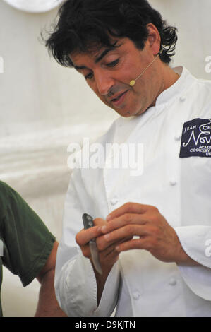 Woodstock, Oxfordshire, UK. 21st June 2013. Jean-Christophe Novelli demonstrates how to cook an aubergine at the Blenheim Palace Flower Show, Woodstock, Oxfordshire UK 21st June 2013.  Today was opening day of the show which runs from 21st to 23rd June.  The show attracted thousands of visitors on the opening day who came to see stunning floral displays, gardening products, food and drink stands and celebrity speakers. Credit:  Julian Eales/Alamy Live News Stock Photo