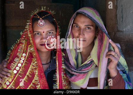 Two Gaddi tribeswomen pose for the camera at the Himalayan village of Kugti in Himachal Pradesh, India Stock Photo