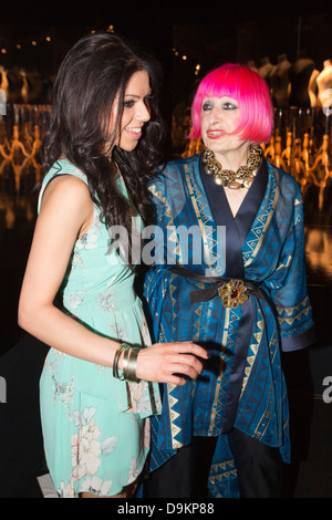 Fashion designer Zandra Rhodes (right) with a guest at Graduate Fashion Week, Gala Show. Stock Photo