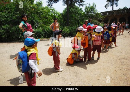 group of infants and their companions on their way to Parc Guell Barcelona Spain Stock Photo