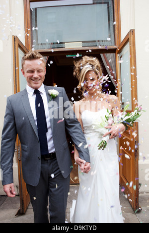 Confetti thrown at bride and groom at wedding ceremony Stock Photo