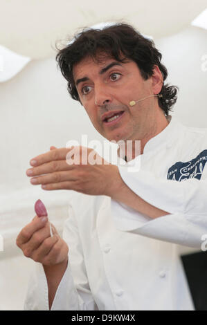 Woodstock, Oxfordshire, UK. 21st June 2013. Jean-Christophe Novelli shows new season wet garlic in a demonstration at the Blenheim Palace Flower Show, Woodstock, Oxfordshire UK 21st June 2013.  Today was opening day of the show which runs from 21st to 23rd June.  The show attracted thousands of visitors on the opening day who came to see stunning floral displays, gardening products, food and drink stands and celebrity speakers. Credit:  Julian Eales/Alamy Live News Stock Photo