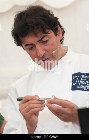 Woodstock, Oxfordshire, UK. 21st June 2013. Jean-Christophe Novelli shows new season wet garlic in a demonstration at the Blenheim Palace Flower Show, Woodstock, Oxfordshire UK 21st June 2013.  Today was opening day of the show which runs from 21st to 23rd June.  The show attracted thousands of visitors on the opening day who came to see stunning floral displays, gardening products, food and drink stands and celebrity speakers. Credit:  Julian Eales/Alamy Live News Stock Photo