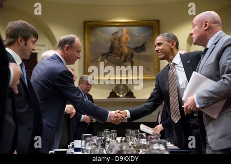 US President Barack Obama drops by a meeting with Russian Security Council Secretary Nikolay Patrushev in the Roosevelt Room of the White House May 22, 2013 in Washington, DC. Stock Photo