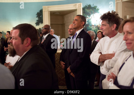 US President Barack Obama attends a farewell party for William Hamilton, a Residence staff member, in the Diplomatic Reception Room of the White House May 21, 2013 in Washington, DC. Stock Photo