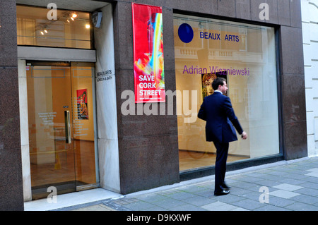 A man walks past an art gallery in Cork Street, London, UK Stock Photo