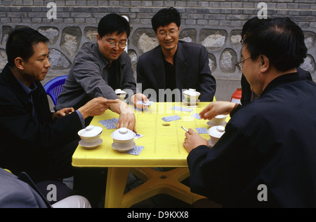 Locals playing cards game in Gansu province China Stock Photo