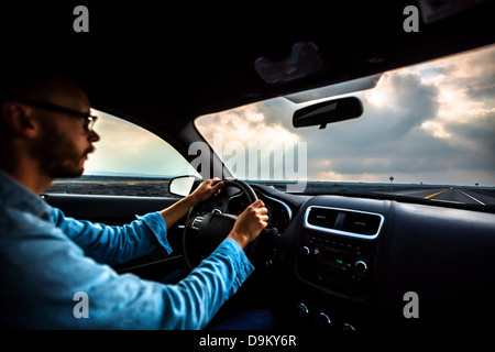 Mid adult man driving car Stock Photo