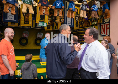 US President Barack Obama congratulates New Jersey Governor Chris Christie while playing the 'TouchDown Fever' arcade game along the Point Pleasant boardwalk May 28, 2013 in Point Pleasant Beach, NJ. Stock Photo