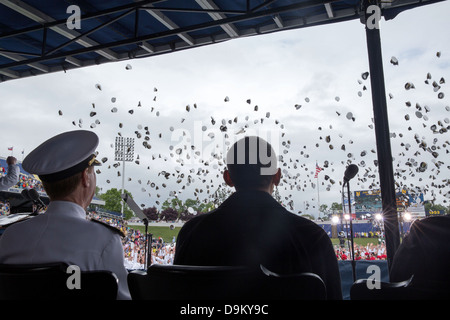US President Barack Obama watches as graduates toss their hats at the conclusion of the US Naval Academy commencement at the Navy-Marine Corps Memorial Stadium May 24, 2013 in Annapolis, MD. Stock Photo