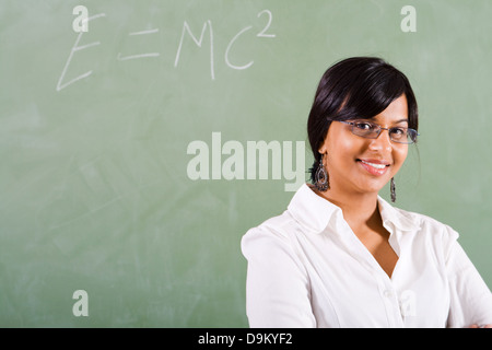 young beautiful school teacher standing in front of blackboard Stock Photo
