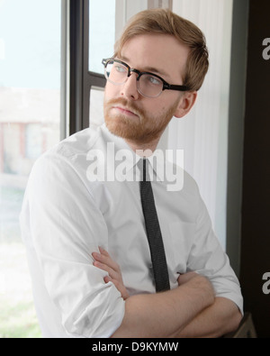 Young man wearing spectacles and tie looking away Stock Photo