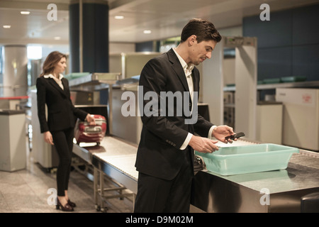 Male passenger with personal belongings in airport security Stock Photo