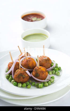 Sweet Corn Balls served with pea pods in a plate Stock Photo
