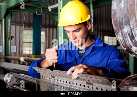 industrial mechanic repairing heavy industry machine Stock Photo