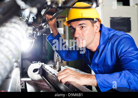 modern machine operator working in factory Stock Photo