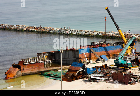 Ship breaking on the Beach, Coastal Freighter run aground in Ajman, United Arab Emirates Stock Photo