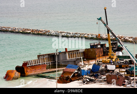 Ship breaking on the Beach, Coastal Freighter run aground in Ajman, United Arab Emirates Stock Photo