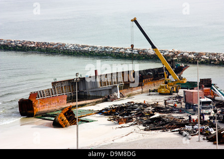 Ship breaking on the Beach, Coastal Freighter run aground in Ajman, United Arab Emirates Stock Photo