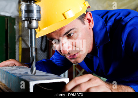 male metal worker using drillpress Stock Photo