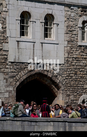 yeoman warder with tour group tower of london england Stock Photo