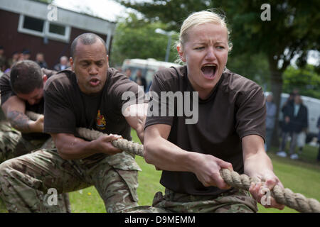 Women British Military Fitness, Grimace Tug of War team at Preston UK, 22 June 2013. 103rd (Lancashire Artillery Volunteers) Regiment Royal Artillery at the Preston Military Show at Fulwood Barracks, Preston, Lancashire .   Servicemen and women, cadets and veterans represent the Royal Navy, the Army and the Royal Air Force from all over the North West: Cheshire, Cumbria, Lancashire, Merseyside and Greater Manchester.  The Preston Military Show is the largest display by the armed forces in the North West of England. Stock Photo