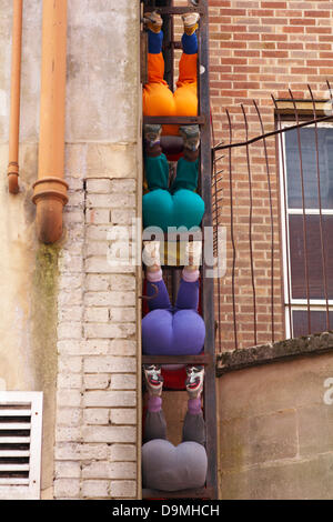 Bournemouth, Dorset UK 22 June 2013. Bodies in Urban Spaces by Austrian choreographer Willi Dorner sees human bodies squeezed into the nooks and crannies of the finest landmarks in Bournemouth. By cramming themselves into doorways, alcoves and any gap they can find, the performers offer different and often hilarious interpretations of urban architecture; unusual physical performance in unusual spaces by Pavilion Dance South West. Stock Photo