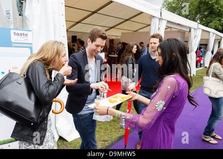 London, UK. 22nd June 2013. Taste of London 2013, visitors sample mango fruit. The event takes place every year in Regents Park, where 40 of the city's top restaurants serve their finest dishes for visitors to sample. London, UK. 22nd June 2013. Photo: Paul Maguire/Alamy Live News Stock Photo