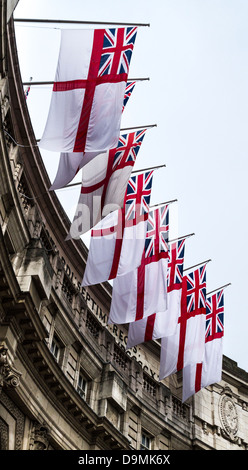 White ensign flags of the Royal Navy adorn Admiralty Arch, Whitehall, London, UK Stock Photo