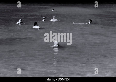 PARADISE BEACH, PHUKET, THAILAND JANUARY 28 2013: Tourists catch some rays while swimming at Paradise Beach Stock Photo