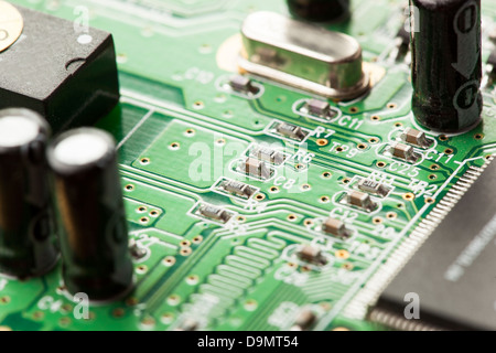 Green Electrical Circuit Board with microchips, conductors, and transistors Stock Photo