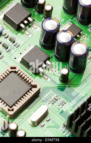 Green Electrical Circuit Board with microchips, conductors, and transistors Stock Photo