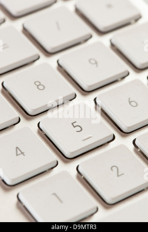 Number Keypad on a Grey Computer Keyboard with white keys for typing Stock Photo