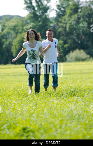 (Model release) Young couple running in park Stock Photo