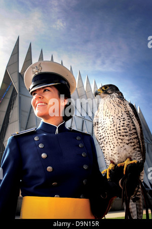 US Air Force Academy Cadet 1st Class Danielle Cortez poses with Destiny, an Air Force Academy falcon outside the Cadet Chapel May 24, 2013 in Colorado Springs, CO. Cortez spent her four years at the Academy as a falconer, working with all the falcons. Stock Photo