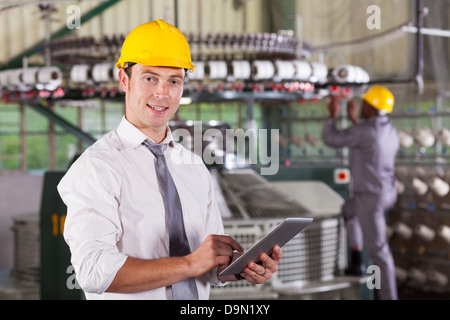 modern textile factory manager using tablet computer Stock Photo