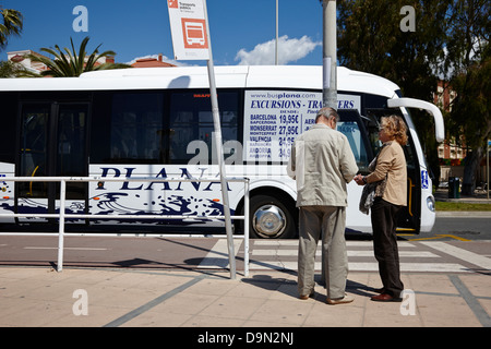 two elderly passengers waiting to board plana bus Cambrils Catalonia Spain Stock Photo