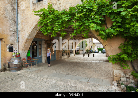 One of the many arches with shops and cafes around the Place des Cornieres in Monpazier, Dordogne, France Stock Photo